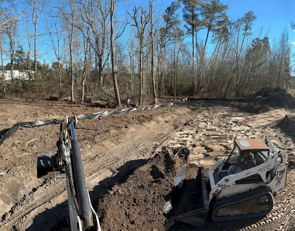 Bobcat skid steer on a graded lot with silt fence on the Delmarva Peninsula